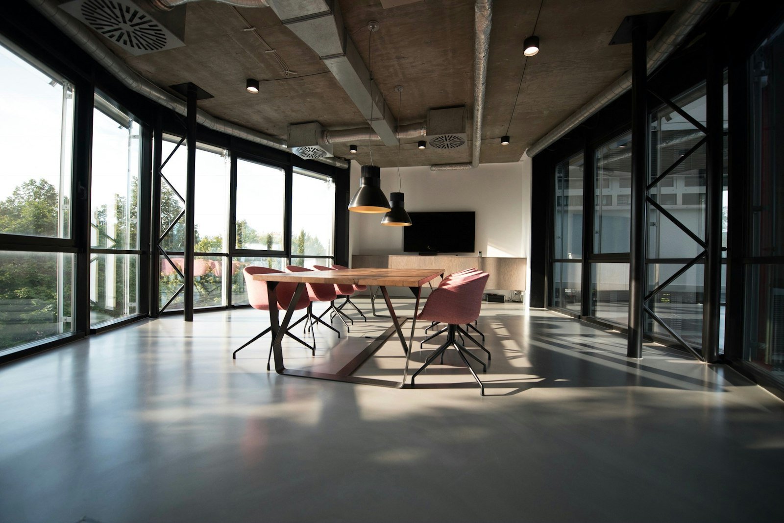 Quiet meeting room with a long table, used as a working space for product and finance conversations.